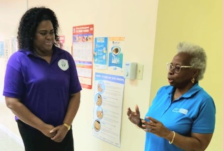 Founder of charity entity, A Lyttle Goes a Far Way Foundation, Jamaican and United States based Human Rights Consultant, Kay Lyttle (left), in discussion with Vision Care Coordinator at the Jamaica Society for the Blind (JSB), Sandra Harris, during the handover of care packages to the Society, in Kingston, recently.