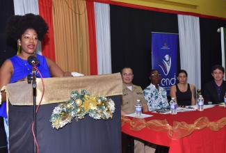  Spanish Education Officer in the Ministry of Education, Skills, Youth and Information, Ramonia Smith Hamilton, brings remarks at the closing ceremony for the three-month Spanish Course for Public Servants on Thursday (Dec. 11) at the Ministry’s Caenwood Centre on Arnold Road in Kingston. The course was offered by the Embassy of the Republic of Colombia, and participants were certified by Pontifical Bolivarian University in Colombia. Listening (seated, from left) are Naval Attaché for the Embassy of the Republic of Colombia to Jamaica, Captain Cesar Alberto Fernandez Medina; Administrative Assistant, Carolann Cole, representing Ambassador of the Republic of Columbia to Jamaica, Her Excellency Emiliana Bernard Stephenson; Professor at Pontifical Bolivarian University, Maria Teresa Espinosa; and Spanish Tutor, Camilo Arevalo.