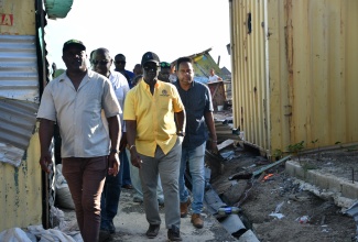 Minister of Local Government and Community Development, Hon Desmond McKenzie (second left), tours a section of the Savanna-La-Mar Market in Westmoreland on Wednesday (December 3), to assess the damage caused by the recent passage of Hurricane Melissa. Joining him are (from left) Councillor of the Little London Division, Ian Myles; Mayor of Savanna-la-Mar, Councillor Danree Delancy (partially hidden), and Chief Technical Director in the Ministry, Dwight Wilson.
