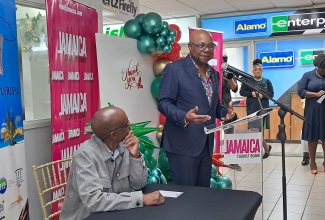 Tourism Minister, Hon. Edmund Bartlett (at podium), delivers remarks during the annual Staff Appreciation Breakfast for Norman Manley International Airport (NMIA) workers, held at the Kingston terminal on Monday (December 15). During the event, Minister Bartlett officially opened Jamaica’s 2025/26 winter tourist season and expressed confidence in the sector’s rapid rebound following Hurricane Melissa. Listening is Jamaica Hotel and Tourist Association (JHTA) President, Christopher Jarrett.