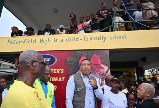 Prime Minister, Dr. the Most Hon. Andrew Holness (centre) addresses residents at the Petersfield High School in Westmoreland on Saturday (December 13) during the Prime Minister