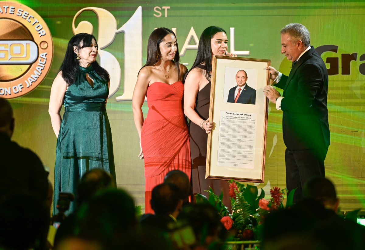 Daughters of the late Don Wehby, Stephanie (second left) and Abigail, accepting a plaque from President, Private Sector Organisation of Jamaica (PSOJ), Metry Seaga, inducting Mr. Wehby in the PSOJ 31st Hall of Fame. The black-tie gala event was held at The Jamaica Pegasus in New Kingston on Monday (December 15). Sharing in the moment is Mr. Wehby