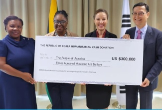 Minister of Foreign Affairs and Foreign Trade, Senator the Hon. Kamina Johnson Smith (second right), receives a cheque valued at US$300,000 from Chargé d’Affaires at the Embassy of the Republic of Korea, Jin-wook Kim (right), to support Jamaica’s recovery and reconstruction efforts following Hurricane Melissa. The presentation ceremony was held recently at the Ministry’s offices in downtown Kingston. Also present were Chief Technical Director at the Ministry of Foreign Affairs and Foreign Trade, Ambassador Sharon Miller (left), and Senior Director for Mitigation, Planning and Research at the Office of Disaster Preparedness and Emergency Management (ODPEM), Michelle Edwards.


