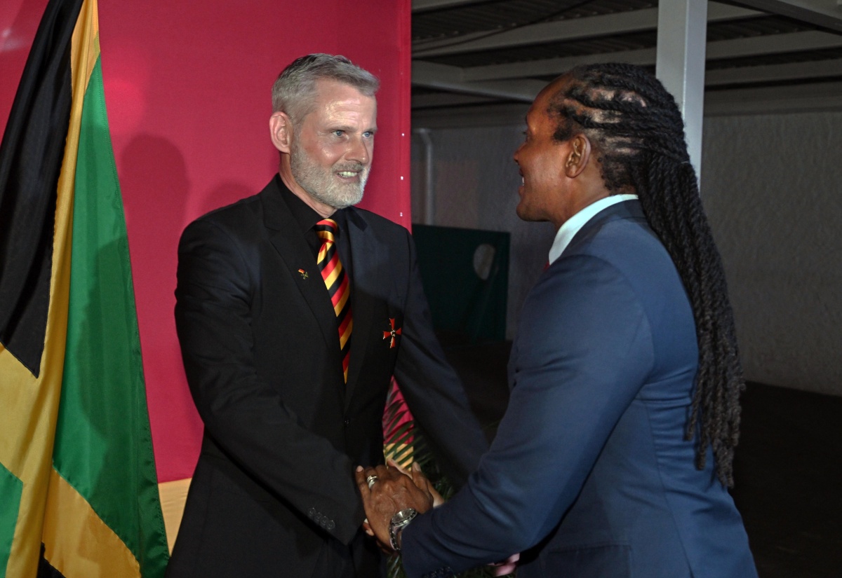 State Minister in the Ministry of Foreign Affairs and Foreign Trade, Hon. Alando Terrelonge (right), is welcomed to a reception marking Germany’s National Day by Ambassador of the Federal Republic of Germany to Jamaica, His Excellency Jan Hendrik van Thiel. The event was held at the German Embassy in Kingston on Thursday (December 4).

