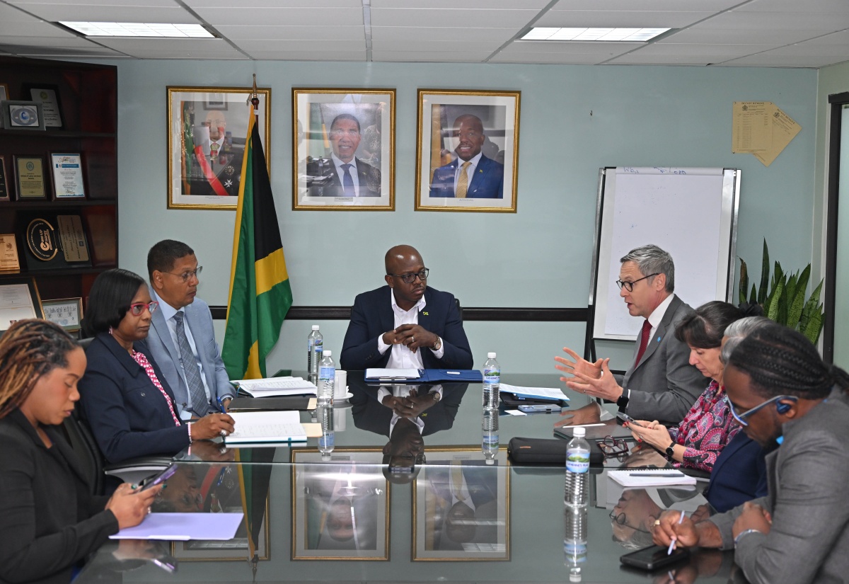 Minister of Labour and Social Security, Hon. Pearnel Charles Jr. (head of table), listens to a presentation from United Nations Children Fund (UNICEF) Regional Director for Latin America and the Caribbean, Roberto Benes (fourth right), during a courtesy call by a UNICEF delegation at the Ministry’s North Street offices in Kingston on Friday (Dec. 12). The Ministry’s team included Acting Permanent Secretary, Dione Jennings (second left); and State Minister, Hon. Donovan Williams (third left).