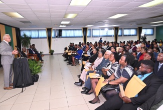 Minister of Justice and Constitutional Affairs, Hon. Delroy Chuck, addresses the commissioning ceremony for 80 Justices of the Peace (JPs) for Kingston, held on Thursday (Dec. 4), at the Kingston Bookshop in downtown Kingston.