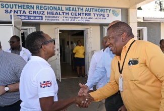 Regional Director with the Southern Regional Health Authority (SRHA), Michael Bent (right), greets United Kingdom (UK) High Commissioner to Jamaica, Her Excellency Alicia Herbert (left), at the Santa Cruz Health Centre in St. Elizabeth, on December 2. Partially hidden is Chairman of the SRHA, Wayne Chen.

