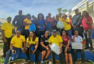 Members of the Friends of Region 6 are joined by Jamaica Constabulary Force (JCF) personnel and educators during a visit to the Brampton Primary and Infant School in St. Elizabeth on November 28. The group distributed hurricane relief supplies valued at over $500,000 to the institution, along with Black River Primary and Infant, also in St. Elizabeth.

