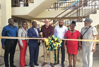 Minister without Portfolio in the Ministry of Economic Growth and Infrastructure Development with Responsibility for Land Titling and Settlements, Hon. Robert Montague (third left), and Opposition Leader and Member of Parliament for St. Andrew Southern, Mark Golding (centre), cut the ribbon to mark the completion of the $58-million Torrington Park Rehabilitation Project on Tuesday (December 9). They are joined by (from left) Caretaker for St. Andrew Southern, Carlton Allen; Ministry officials, Senior Director, Christina Gardner, and Director of Projects, Phillip Stephenson; Councillor for the Admiral Town Division, Louise Newland; and Contractor, Orrett Wellington.