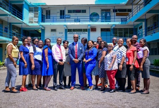 Principal of the Frankfield, Clarendon-based Edwin Allen High School, Jermaine Harris (centre), shares a photo opportunity with members of staff at the school.

