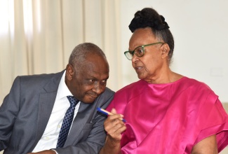 Chairman of the National Prayer Vigil of Jamaica Prayer and Promotions Committee, Dr. Patricia Holness (right), and Chairman of the National Prayer Vigil, the Reverend Errol Rattray, are in discussion at a press conference on December 9, at the Medallion Hall Hotel in Kingston.

