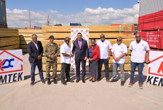 Prime Minister, Dr. the Most Hon. Andrew Holness (fourth left), greets Kemtek Development and Construction Limited’s Chairman and Managing Director, Sylvester Tulloch, during Thursday’s (December 18) ceremony for the handover of building supplies to the Office of Disaster Preparedness and Emergency Management (ODPEM). The presentation was made at Kemtek’s warehouse at Oak Estate in Greater Bernard Lodge, Portmore, St. Catherine. Also participating are (from left) Managing Director of the Jamaica Social Investment Fund (JSIF), Omar Sweeney; Acting Chief of Defence Staff, Brigadier Mahatma Williams; ODPEM Senior Director of Mitigation Planning and Research, Michelle Edwards; and Kemtek Directors Garwin Tulloch, Handel Tulloch, and Karl Tulloch. The supplies, part of Kemtek’s $70-million Hurricane Melissa relief initiative, will aid communities in Westmoreland, St. Elizabeth, Trelawny and St. James.

