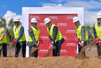 Prime Minister, Dr. the Most Hon. Andrew Holness (third right), breaks ground for the US$20 million Lakes Pen Industrial Park in St. Catherine on Tuesday (December 9). He is joined by (from left) Business Development Manager, China Harbour Engineering Company (CHEC), Ivan Wu; Co-Founder, Executive Vice President and Chief Operating Officer, Sygnus Capital, Dr. Ike Johnson; Minister of Industry, Investment and Commerce, Senator the Hon. Aubyn Hill; Chairman, Sygnus Real Estate Finance Limited, Horace Messado; and Vice President and Head of Real Estate and Project Finance, Sygnus Capital, David Cummings. The Lakes Pen Industrial Park, being developed by Sygnus, is being designed to meet growing demand for warehousing, logistics, and light industrial space.

