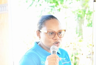 Health Promotion and Education Officer for Hanover, Andrene Smith-Benjamin, speaks to persons visiting the Ramble Health Centre in the parish on Thursday (Dec. 18), during a Ministry of Health and Wellness health outreach.