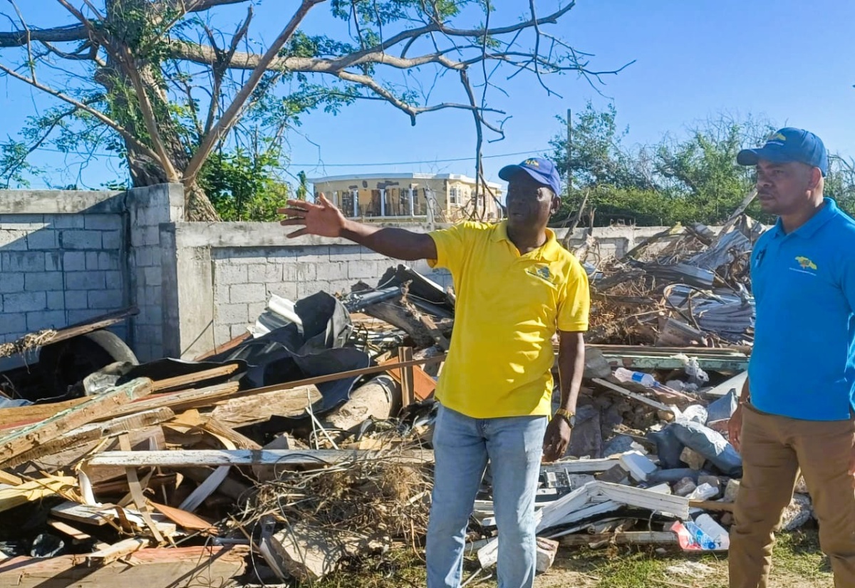Executive Director of the National Solid Waste Management Authority (NSWMA), Audley Gordon (left), in discussion with Regional Operations Manager at SPM Waste Management Ltd., Sheldon Smith, about clean-up operations in  Black River, St. Elizabeth, on Monday (December 29), following the passage of Hurricane Melissa.

