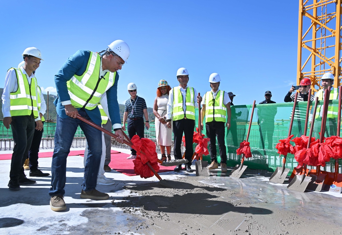 Prime Minister, Dr. the Most Hon. Andrew Holness,  pours the symbolic final concrete mix on the 28th floor of the landmark Pinnacle – Jamaica’s tallest building – in Montego Bay, St. James, on December 10.

