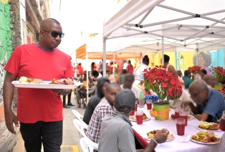 Mayor of Kingston, Councillor Andrew Swaby (standing), prepares to serve residents of the city’s homeless shelters during the Kingston and St. Andrew Municipal Corporation’s (KSAMC) annual Christmas Dinner, held on Thursday (December 25). The event, hosted at Water Lane in downtown Kingston, brought together beneficiaries from the Desmond McKenzie Transitional Centre for the Homeless and the Marie Atkins Night Shelter, offering fellowship, care and festive cheer.

