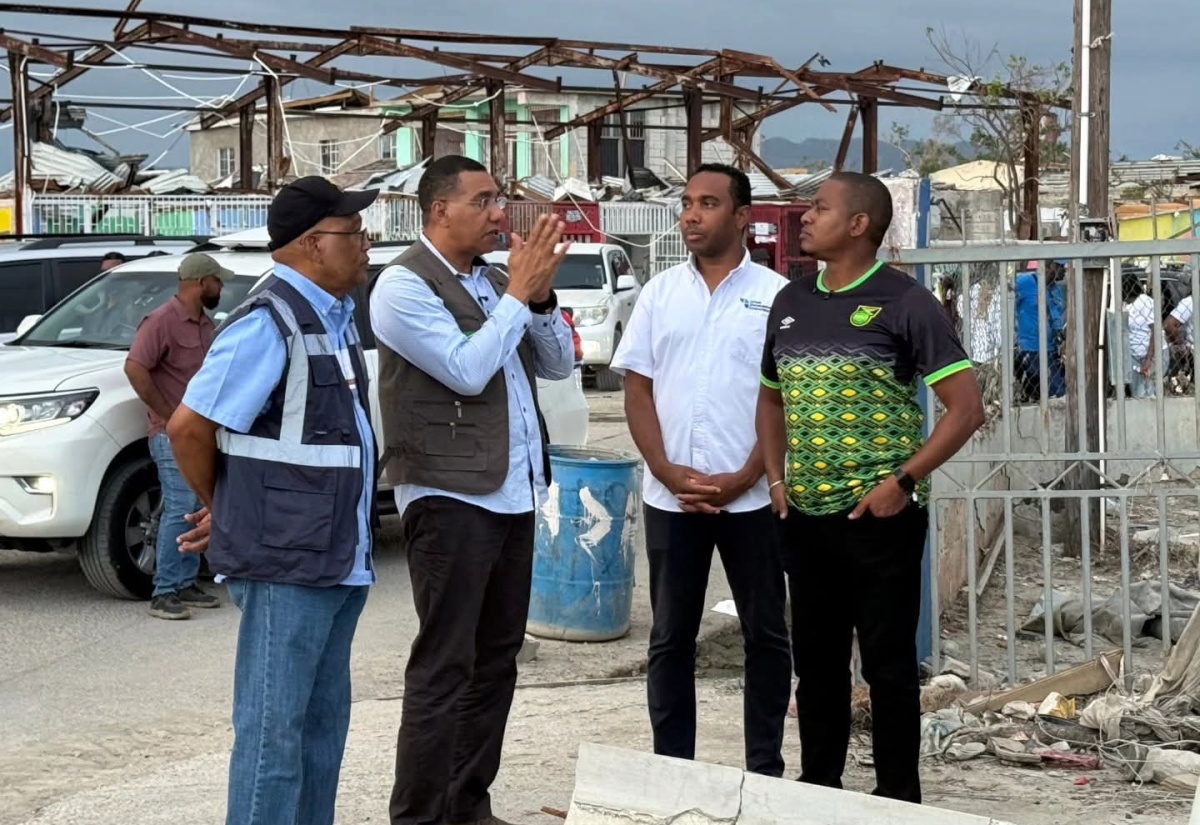 Prime Minister, Dr. the Most Hon.  Andrew Holness (second left), has the full attention of Minister of Agriculture, Fisheries and Mining, Hon. Floyd Green (right); Chairman of the Urban Development Corporation (UDC), Norman Brown (left), and General Manager of the UDC, Robert Honeyghan, as they discuss the UDC’s lead role in clean-up efforts in Black River, St. Elizabeth, during a visit on December 13.

