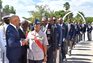 Governor-General, His Excellency the Most Hon. Sir Patrick Allen (left), greets Retired Jamaica Defence Force (JDF) Sergeant, Peter Williams, during the annual Remembrance Day ceremony at National Heroes Park in Kingston.