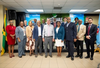Minister of Energy, Transport and Telecommunications, Hon. Daryl Vaz (centre), shares a photo opportunity with Acting Director General of the Jamaica Civil Aviation Authority (JCAA), Nicole Morgan (fourth right), and other stakeholders during the official launch of Jamaica’s Sustainable Aviation Fuels (SAF) Feasibility Study at the JCAA headquarters in Kingston on Tuesday (January 20)

