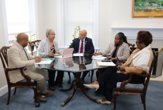 Jamaica’s Ambassador to the United States, His Excellency Major General (Ret’d) Antony Anderson (centre), discusses Jamaica’s overseas employment programmes with Permanent Secretary in the Ministry of Labour and Social Security, Colette Roberts Risden (second left), who has oversight responsibility for overseas employment programmes in the United States and Canada, during a meeting at the Embassy of Jamaica in Washington, D.C. Also participating are Liaison Officers in the Ministry, Sheldon Brown, and Karlene Brown (right), and Minister Counsellor for Trade and Economic Affairs at the Embassy, Aliecia Taylor.