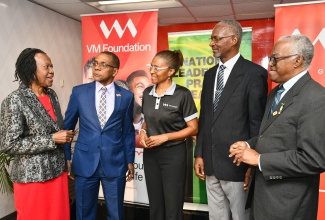 Chairman of the National Leadership Prayer Breakfast Committee (NLPBC), Pastor Claudia Ferguson (left), has the attention of (from second left) President and Chief Executive Officer of the VM Group, Courtney Campbell; Chief Executive Officer of the VM Foundation, Samantha Charles; Secretary of NLPBC, Rev. Dr. Wayneford McFarlane, and member of Manning’s School Past Students' Association, Jonathan Brown. The occasion was a recent press briefing at the VM Group on Half-Way Tree Road in St. Andrew, to outline details for the 46th Annual National Leadership Prayer Breakfast, which will be held at the Boulevard Baptist Church in St. Andrew, on January 15, beginning at 7:30 a.m.

