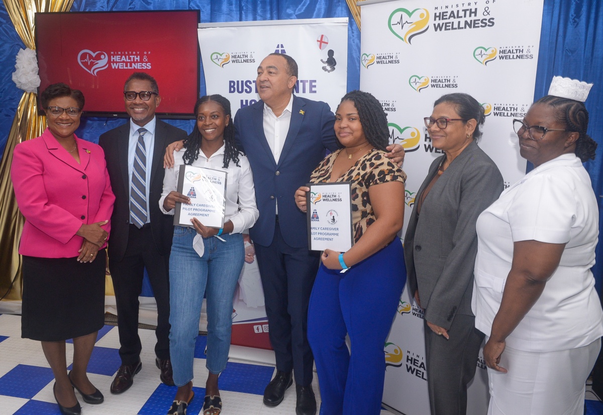 Minister of Health and Wellness, Dr. the Hon. Christopher Tufton (centre), embraces two parents who have signed up for the Family Caregivers Pilot Programme, which was launched on January 19 at the Bustamante Hospital for Children (BHC) in St. Andrew. The parents are Tasheka Anderson (third left) and Francine Perry (fifth left). Also at the launch are (from left) Chief Nursing Officer in the Ministry, Patricia Ingram Martin; Chief Executive Officer at the hospital, Anthony Wood; Chief Medical Officer, Dr. Jacquiline Bisasor-McKenzie, and Deputy Director of Nursing Services at the hospital, Michelle Finnikin Campbell.

