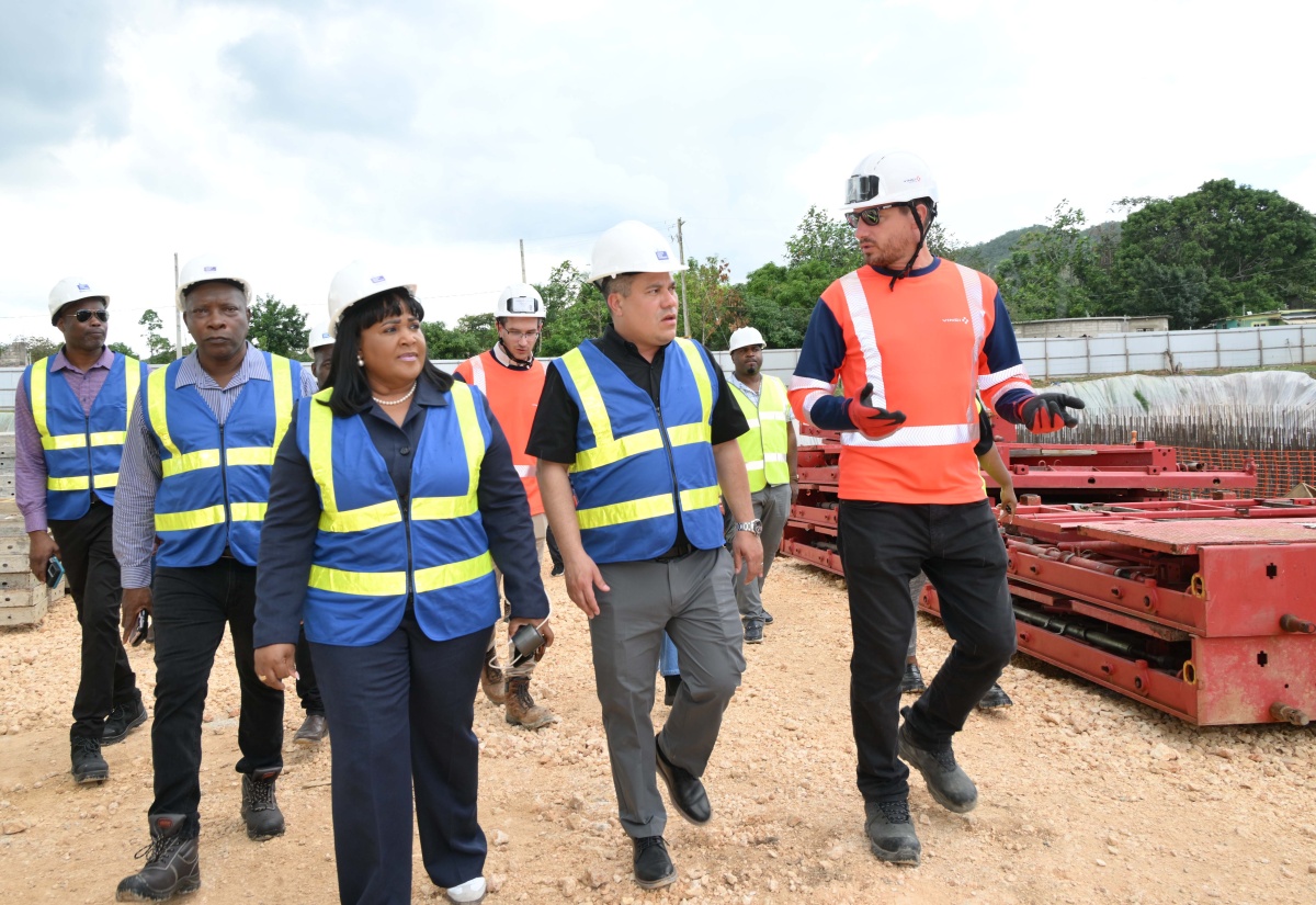 Minister of Water, Environment and Climate Change, Hon. Matthew Samuda (centre), along with Member of Parliament for St. Catherine North Central, Natalie Neita-Garvey (left), and Project Manager with Vinci Construction, Thomas Savary (right), tour the Rio Cobre Water Treatment Plant project, in Content, St. Catherine, on January 29.