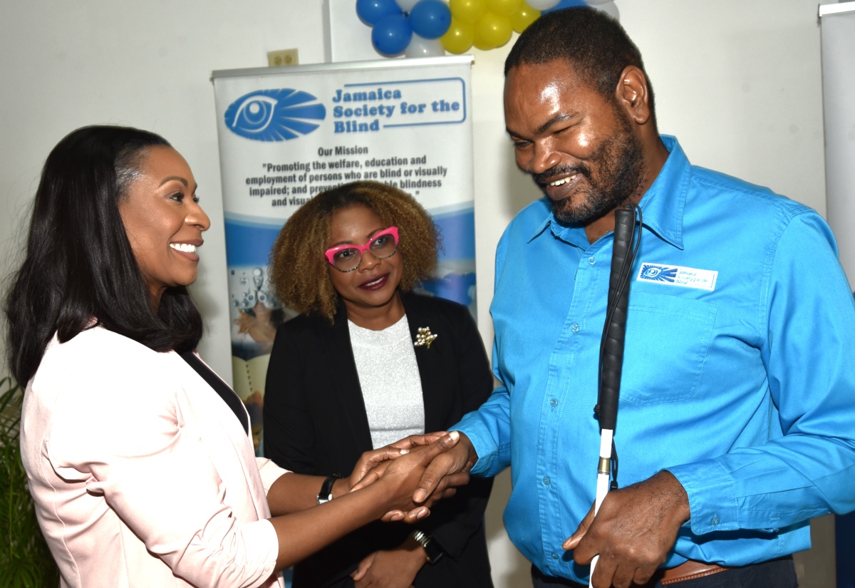 Minister of Education, Skills, Youth and Information, Senator Dr. the Hon. Dana Morris Dixon (centre), observes as Managing Director of the HEART/NSTA Trust, Dr. Taneisha Ingleton, extends greetings to Chairman of the Jamaica Society for the Blind (JSB), Damion McLean, during the handover ceremony for HEART’s Region I National Development Project, held at the JSB in Kingston on January 15.

