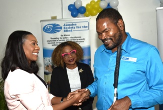 Minister of Education, Skills, Youth and Information, Senator Dr. the Hon. Dana Morris Dixon (centre), observes as Managing Director of the HEART/NSTA Trust, Dr. Taneisha Ingleton, extends greetings to Chairman of the Jamaica Society for the Blind (JSB), Damion McLean, during the handover ceremony for HEART’s Region I National Development Project, held at the JSB in Kingston on January 15.

