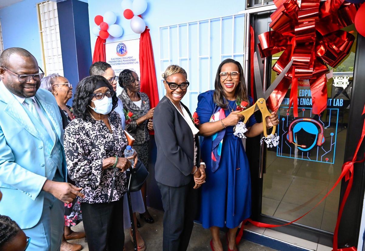 Permanent Secretary in the Ministry of Education, Skills, Youth and Information, Dr. Kasan Troupe (right), cuts the ribbon to officially open the Electronic Document Preparation and Management (EDPM) and Customer Engagement Laboratory at Stony Hill Technical High School in St. Andrew on January 9. Joining her are State Minister in the Ministry of National Security and Peace and Member of Parliament for St. Andrew West Rural, Hon. Juliet Cuthbert Flynn (second right), along with other stakeholders.