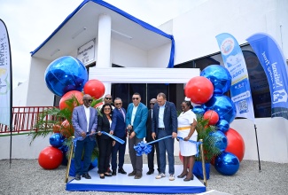 Prime Minister, Dr. the Most Hon. Andrew Holness (fourth right), cuts the ribbon to officially open the new Parent Overnight Suite at the Bustamante Hospital for Children in Kingston on Friday (January 30). The 36-bed facility, constructed at a cost of over $140 million, was delivered through a partnership involving the National Housing Trust (NHT), the National Health Fund (NHF), and the South East Regional Health Authority (SERHA). Also pictured (from left) are: NHT Chairman, Linval Freeman; Senior Medical Officer at the Bustamante Hospital, Dr. Michelle Ann Richards-Dawson; NHF Deputy Chairman, Michael Stern; SERHA Chairman, Wentworth Charles; Minister of Health and Wellness, Dr. the Hon. Christopher Tufton; and Acting Director of Nursing Services at the hospital, Michelle Finnikin Campbell. In the background is Member of Parliament for St. Andrew South Eastern, Julian Robinson.