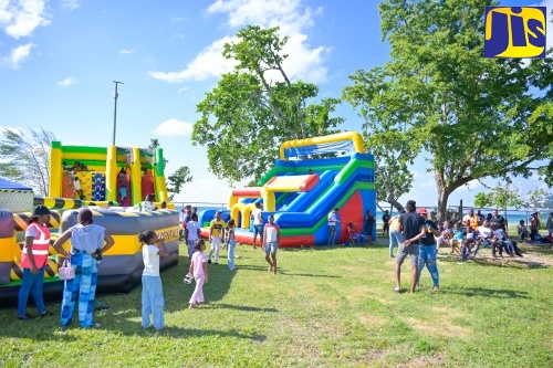 Children enjoying a ride, slide, bounce house and other activities during the Kiddies Treat segment of the Urban Development Corporation's (UDC) Fireworks Festival held at the Long Bay Beach Football Field in Negril, Westmoreland on Wednesday (Dec.31).