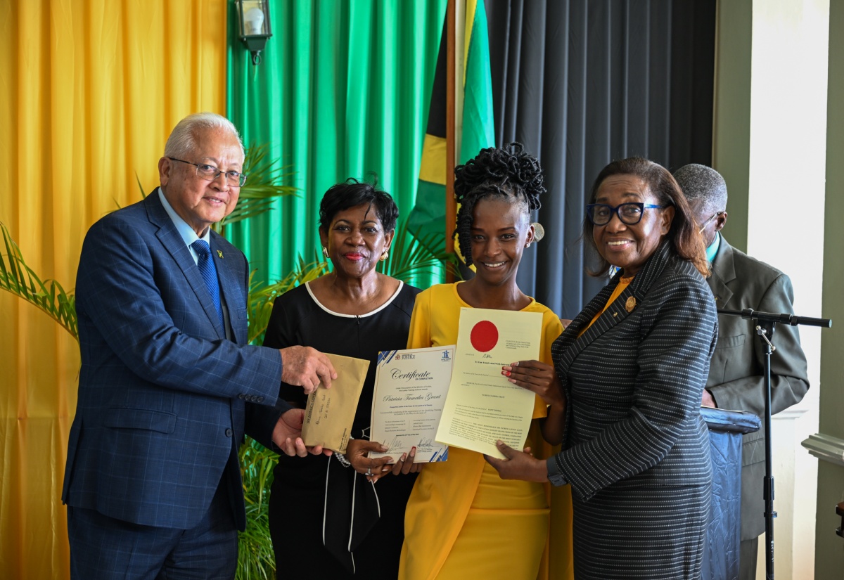 Minister of Justice and Constitutional Affairs, Hon. Delroy Chuck (left); High Court Judge, Hon. Sonia Bertram Linton (second left); and Custos of St. Thomas, Marcia Bennett (right), present new Justice of the Peace (JP) for St. Thomas, Patricia Grant, with her documents of office, during a recent commissioning ceremony for JPs for the parish held at the Whispering Bamboo Cove Resort.

