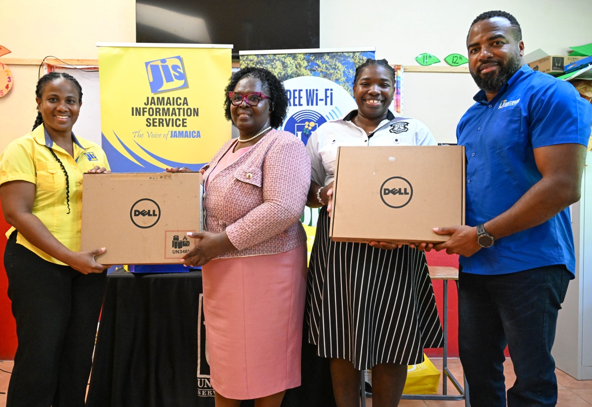 Director, Research, Print and Production at the Jamaica Information Service (JIS), Andrine Davidson (left), and Chief Executive Officer of the Universal Service Fund (USF), Charlton McFarlane (right), present laptops to the Ena Barclay Academy of Excellence on January 23. Receiving are (from second left) Acting Principal, Jacqueline Hendricks-White, and Special Educator, Marla Brown. 

