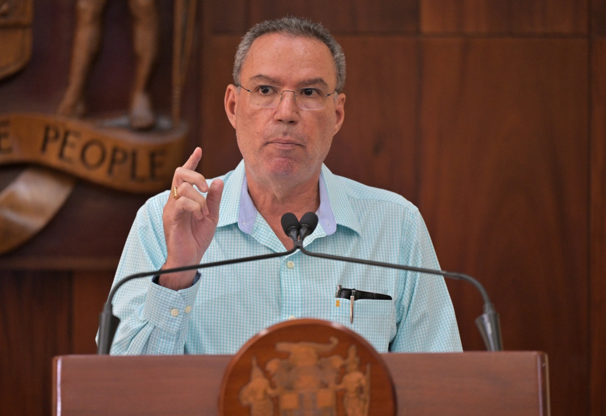 Minister of Energy, Telecommunications and Transport, Hon. Daryl Vaz, hails former Permanent Secretary, Carol Palmer, during a recent post-Cabinet press briefing held at Jamaica House.

