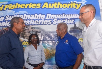 State Minister in the Ministry of Agriculture, Fisheries and Mining, Hon. Franklin Witter (second right), engages with (from left) National Fisheries Authority (NFA) Chief Executive Officer, Dr. Gavin Bellamy; NFA Aquaculture Management Officer, Brittany Oates; and Senior Director in the NFA’s Aquaculture Division, DeHaan Brown, during the National Tilapia Farmers’ Consultation hosted by the NFA on Thursday (January 22) at the Caymanas Golf and Polo Resort in St. Catherine.

