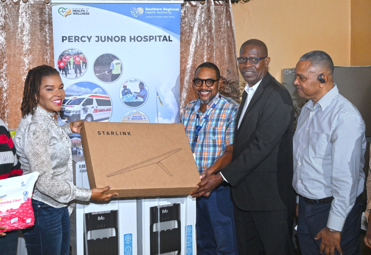 Minister without portfolio in the Office of the Prime Minister with Responsibility for Efficiency, Innovation, and Digital Transformation, Ambassador the Hon. Audrey Marks, who is also Member of Parliament for Manchester North Eastern, presents a Starlink unit to Senior Medical Officer (SMO) at the Percy Junor Hospital, Dr. Carlos Wilson (second left), and Chief Executive Officer, Carlton Nichols (second right). Occasion was the handover of several items at the hospital on Friday (January 16), which will also benefit the adjoining Spalding Health Centre. Looking on is Chairman of the Southern Regional Health Authority (SRHA), Michael Stern. 


