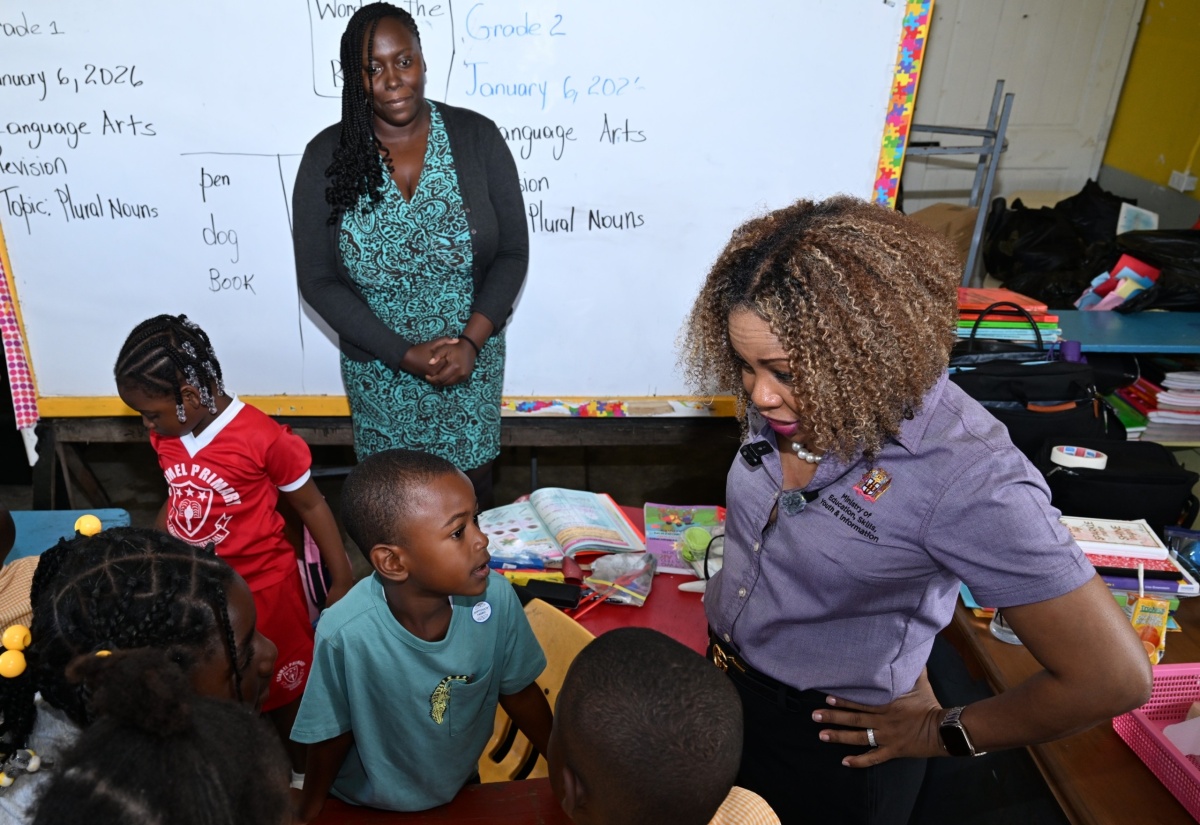 Minister of Education, Skills, Youth and Information, Senator Dr. the Hon. Dana Morris Dixon, engages grade-three and -four students at Carmel Primary and Infant School in Westmoreland, during a tour of the institution on Tuesday (January 6) to observe ongoing rehabilitation work following the impact of Hurricane Melissa. Looking on is teacher Shanice Robinson.