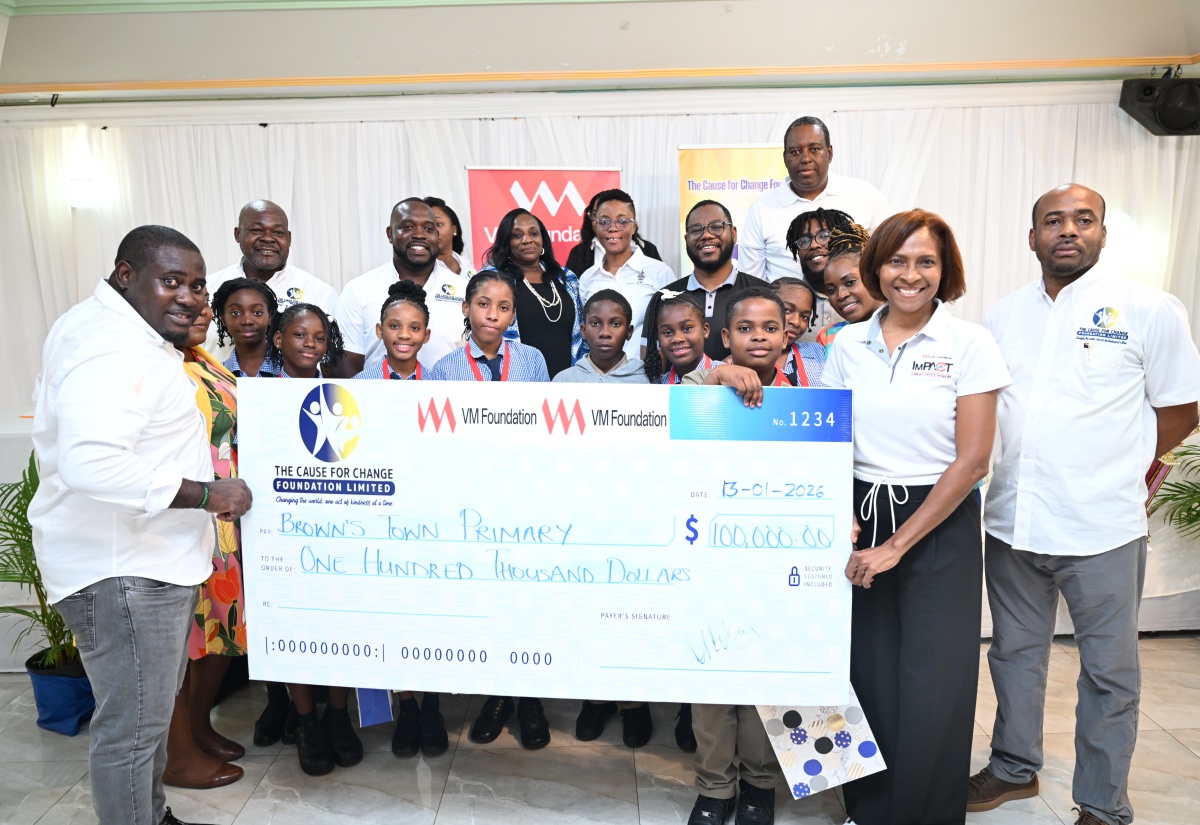 Principal Director of Cause for Change Foundation Limited, Richardo Aiken (left) and Chief Executive Officer of VM Foundation, Samantha Charles (second right), present the winning cheque to students of Brown