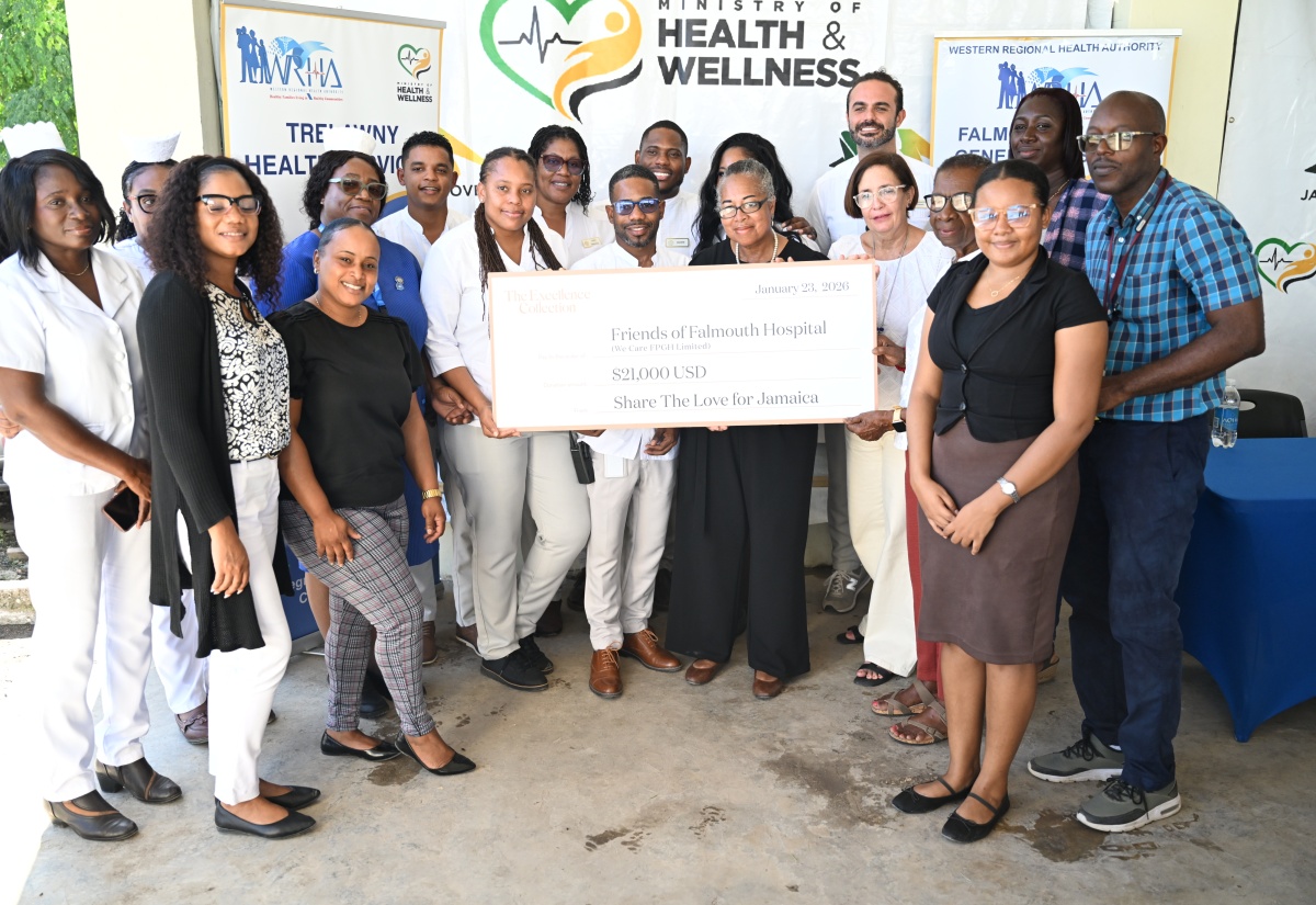 Chief Executive Officer of the Falmouth Public General in Trelawny, Carlington McLennon (second row, right) joins staff of the hospital alongside representatives from Excellence Oyster Bay, as they present a cheque to We Care FPGH’s Winsome Harper (front row, fourth right) during a handover ceremony held on Friday (January 23).