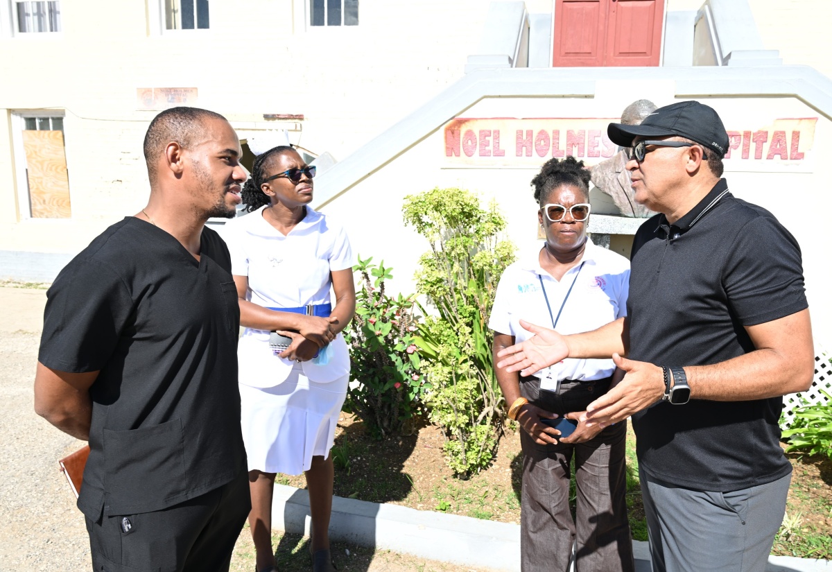 Health and Wellness Minister, Dr. the Hon. Christopher Tufton (right), interacts with (from left) Dr. Paul Garraway; Acting Deputy Director of Nursing Services, Opal Nembhard Ferron; and Chief Executive Officer of the Noel Holmes Hospital in Hanover, Princess Wedderburn, during a tour of the hospital on Saturday (January 24).


