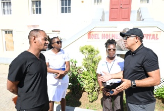 Health and Wellness Minister, Dr. the Hon. Christopher Tufton (right), interacts with (from left) Dr. Paul Garraway; Acting Deputy Director of Nursing Services, Opal Nembhard Ferron; and Chief Executive Officer of the Noel Holmes Hospital in Hanover, Princess Wedderburn, during a tour of the hospital on Saturday (January 24).