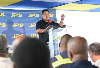 Minister of Water, Environment and Climate Change, Hon. Matthew Samuda, addresses the official commissioning of a 500-kilowatt emergency mobile power generation unit in Darliston, Westmoreland, on Sunday (January 25).

