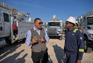 Prime Minister,  Dr. the Most Hon. Andrew Holness (left), in conversation with President and Chief Executive Officer, Jamaica Public Service (JPS), Hugh Grant, at the JPS Hunt