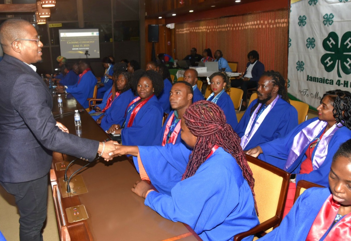 Minister of Agriculture, Fisheries and Mining, Hon. Floyd Green (left), interacts with participants in the Rural Youth Economic Empowerment Programme (RYEEP) Builder, during a graduation ceremony on June 13 last year, at the Jamaica Conference Centre in downtown Kingston.

