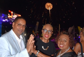 Minister of Culture, Gender, Entertainment and Sport, Hon. Olivia Grange (right), Minister of Finance and Public Service, Hon. Fayval Williams and State Minister for Labour and Social Security, Hon. Donovan Williams, usher in the New Year at the Urban Development Corporation