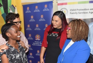 Minister of Education, Skills, Youth and Information, Senator Dr. the Hon. Dana Morris Dixon (right), engages in discussion with awardee, Lisa Smith (left) during the Child Protection and Family Services Agency (CPFSA) 14th Annual Educational Achievement Awards Ceremony on Thursday (January 29) at the Terra Nova All-Suite Hotel in Kingston. Sharing in the moment are Chief Executive Officer (CEO) of the Gore Family Foundation, Christine Gore (second left); and CPFSA CEO, Laurette Adams-Thomas.

