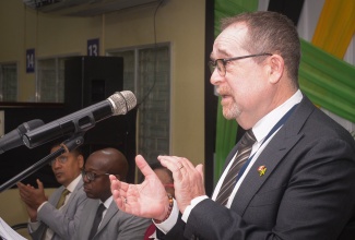 Canada’s High Commissioner to Jamaica, His Excellency Mark Berman (right), addresses a send-off ceremony for seasonal agricultural workers departing for Canada, held at the Ministry of Labour and Social Security’s Overseas Employment Centre on East Street in downtown Kingston, on Tuesday (January 6). Listening (from left) are State Minister in the Ministry of Labour and Social Security, Hon. Donovan Williams; Minister of Labour and Social Security, Hon. Pearnel Charles Jr. and Permanent Secretary in the Ministry, Dione Jennings.