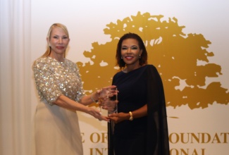 Minister in the Office of the Prime Minister with Responsibility for Efficiency, Innovation and Digital Transformation, Ambassador the Hon. Audrey Marks (right), receives the prestigious 2026 Golden Heart Award from Tree of Life Foundation Founder and President, Amanda Schumacher, during the organisation’s awards ceremony, held on January 11 at the renowned Breakers Palm Beach Resort in Florida.

